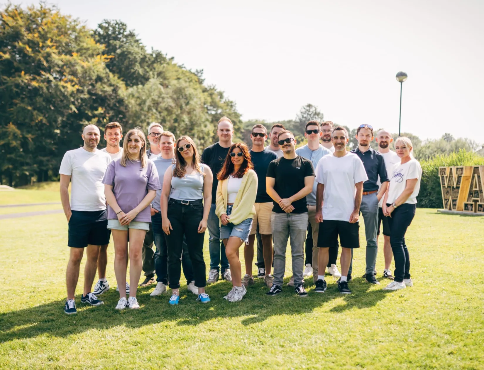 Full team group photo taken outdoors at Ward Park on a sunny day.