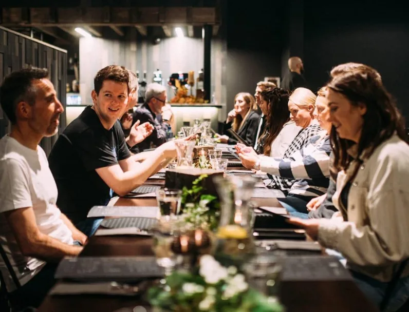 Team gathered at dinner table at the Game of Thrones Studio Tour restaurant.