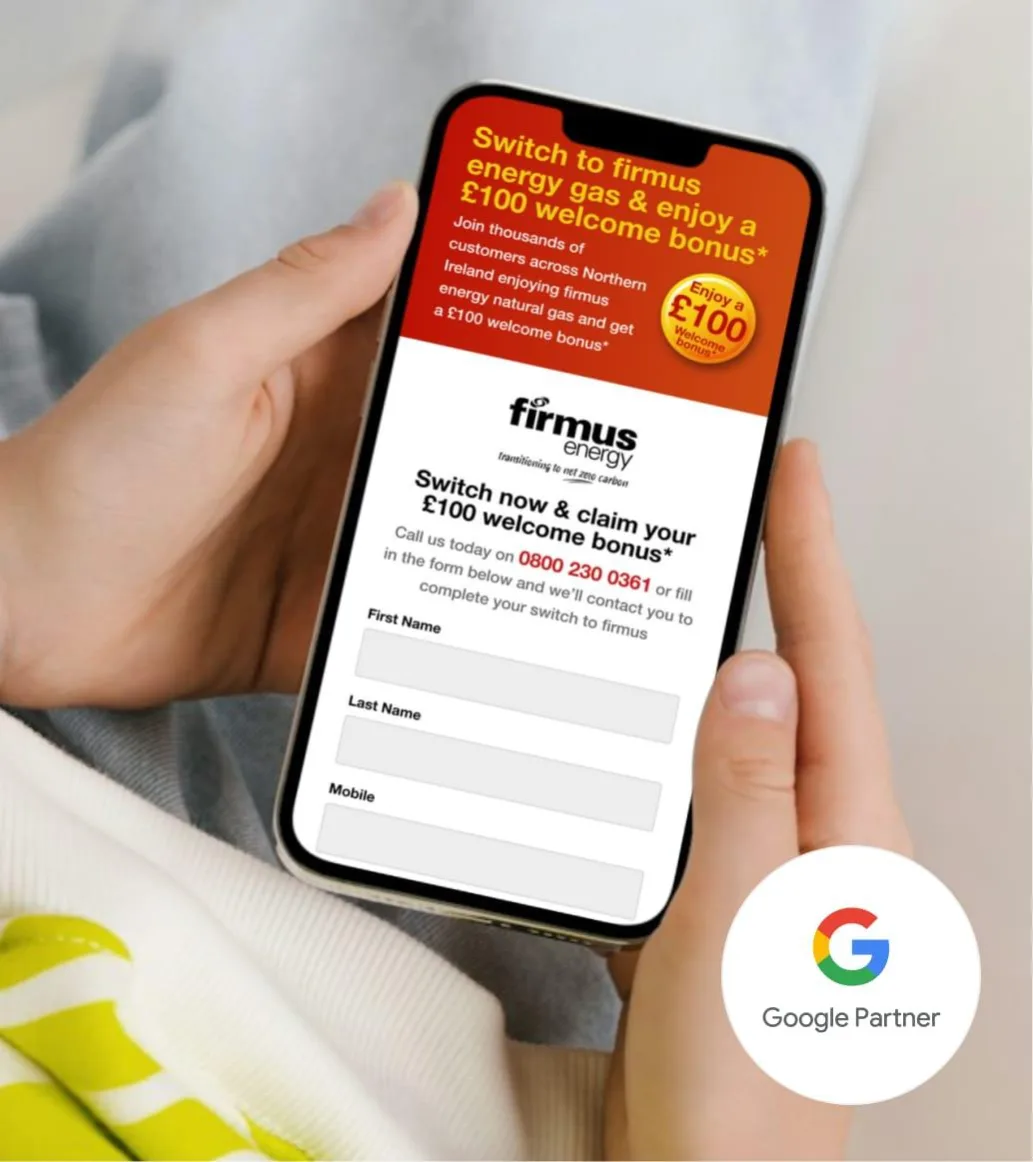 A person holds a phone showing a Firmus Energy £100 welcome bonus offer with a signup form. A Google Partner badge is also visible.