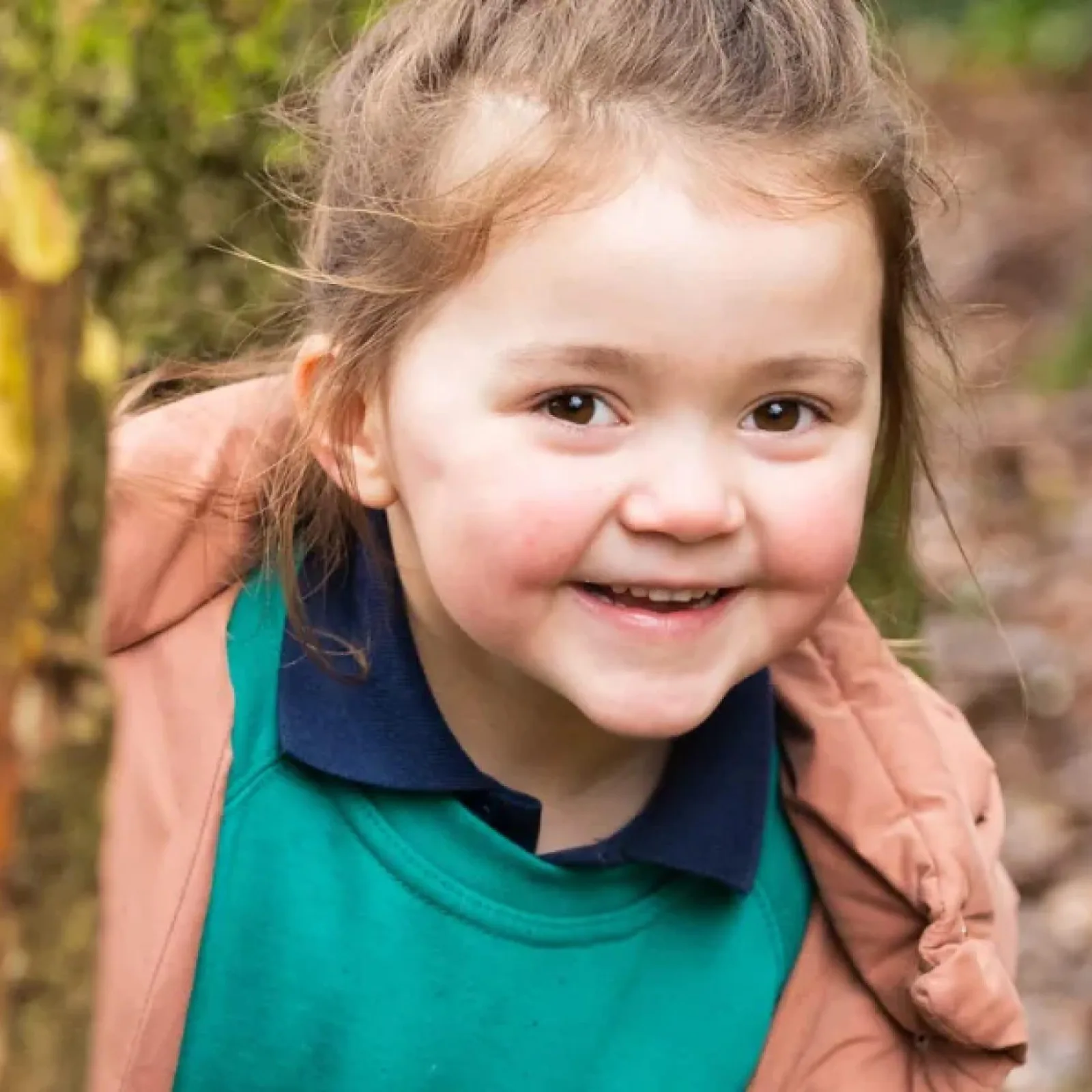 Child smiling playing in forest