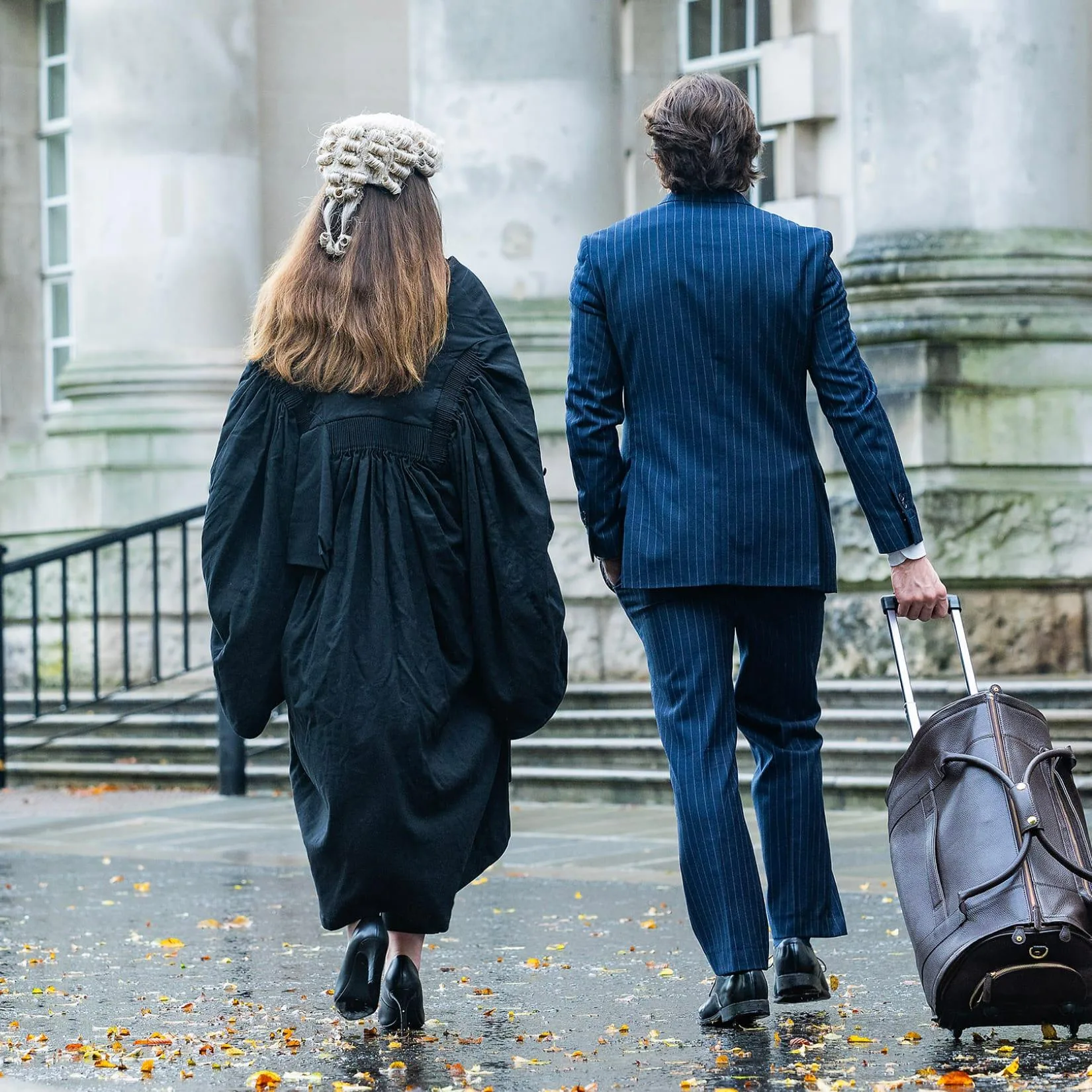 Barrister and client walking into court.