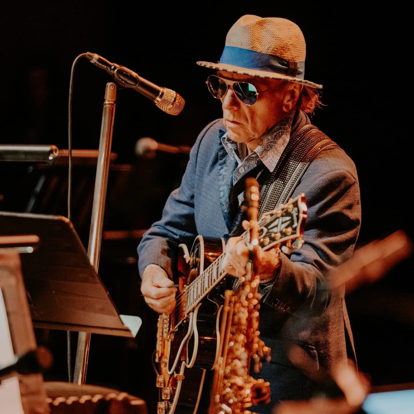 Van Morrison performing on stage with guitar